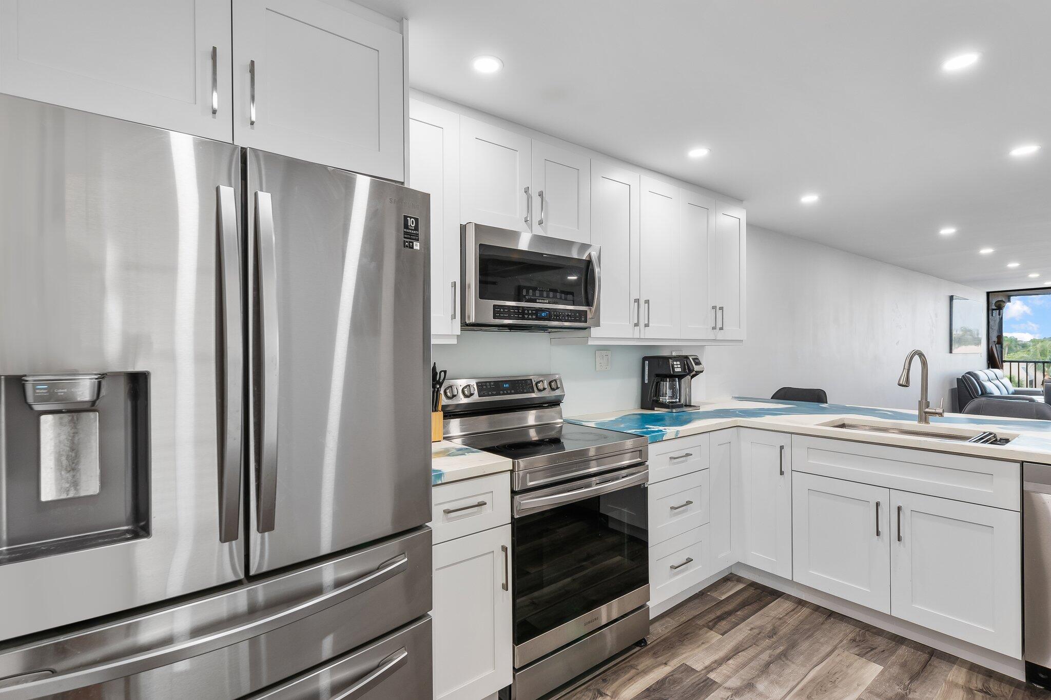 a kitchen with a refrigerator stove and microwave