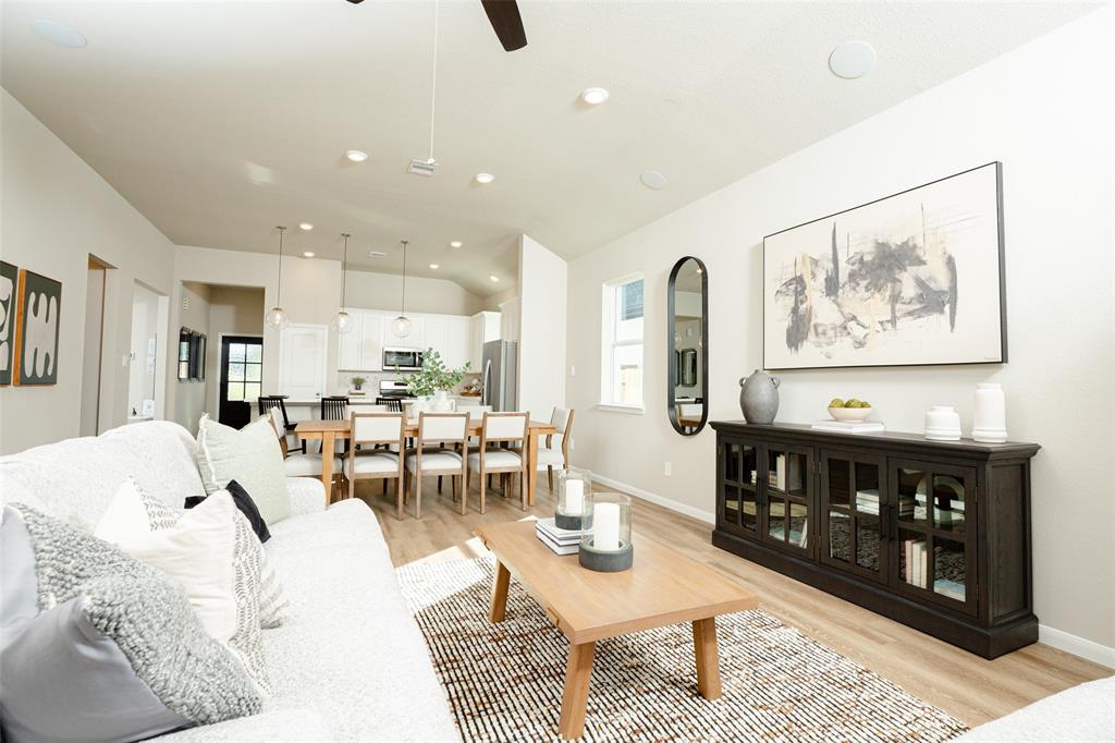 a living room with furniture and wooden floor