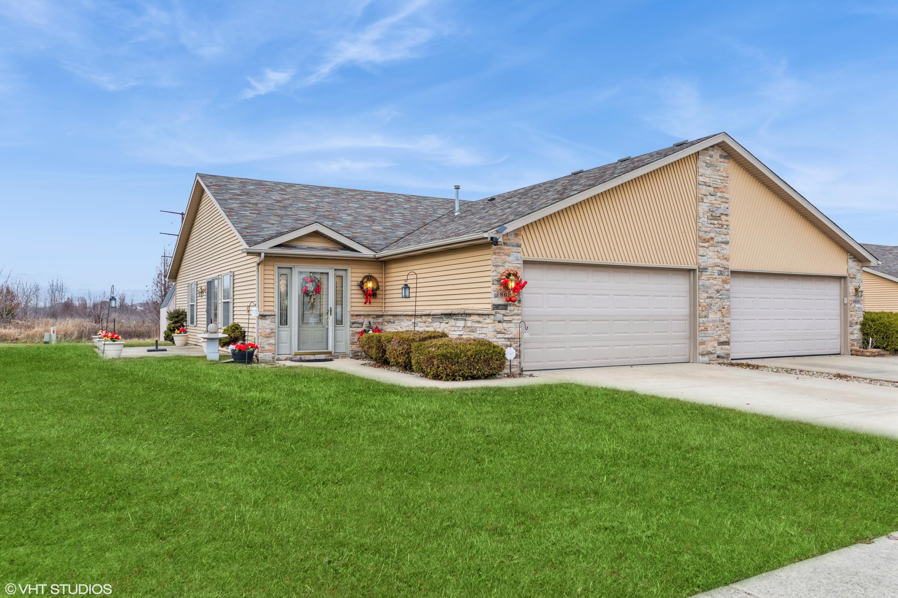 a view of a house with a yard and garage