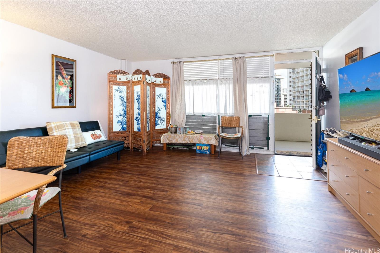 a living room with furniture and wooden floor