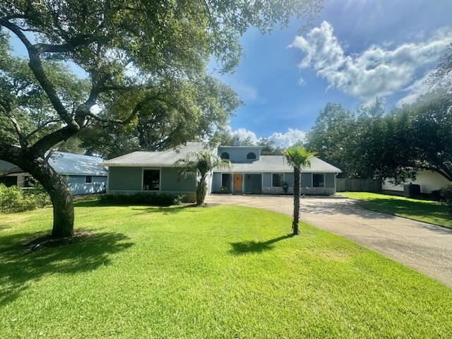 a view of a house with a yard and tree s