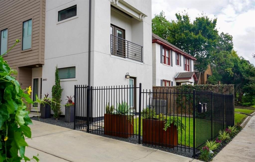 a view of a house with a wooden fence