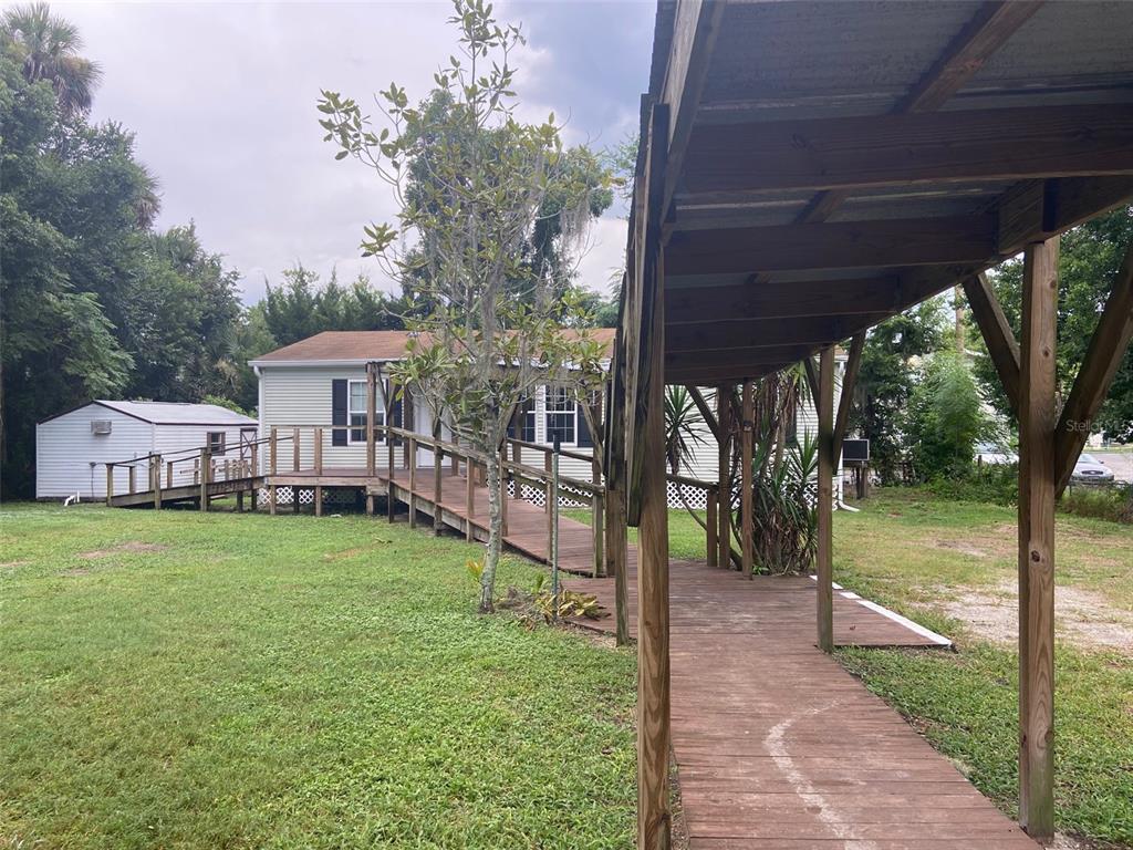 a view of a house with backyard and a sitting area