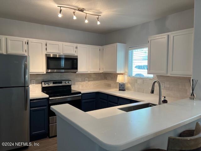 a kitchen that has a sink and a stove top oven