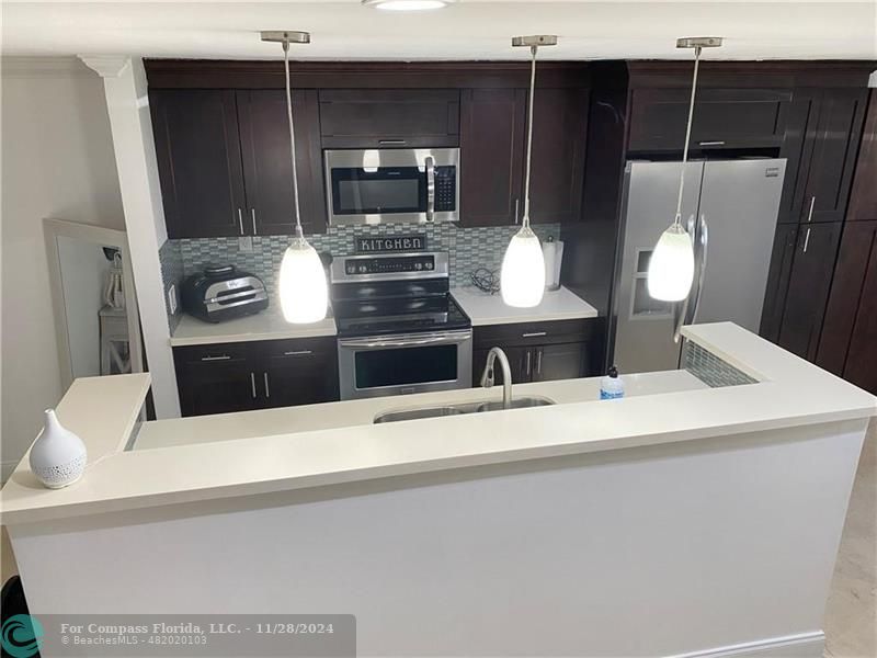 a kitchen with a refrigerator and a stove