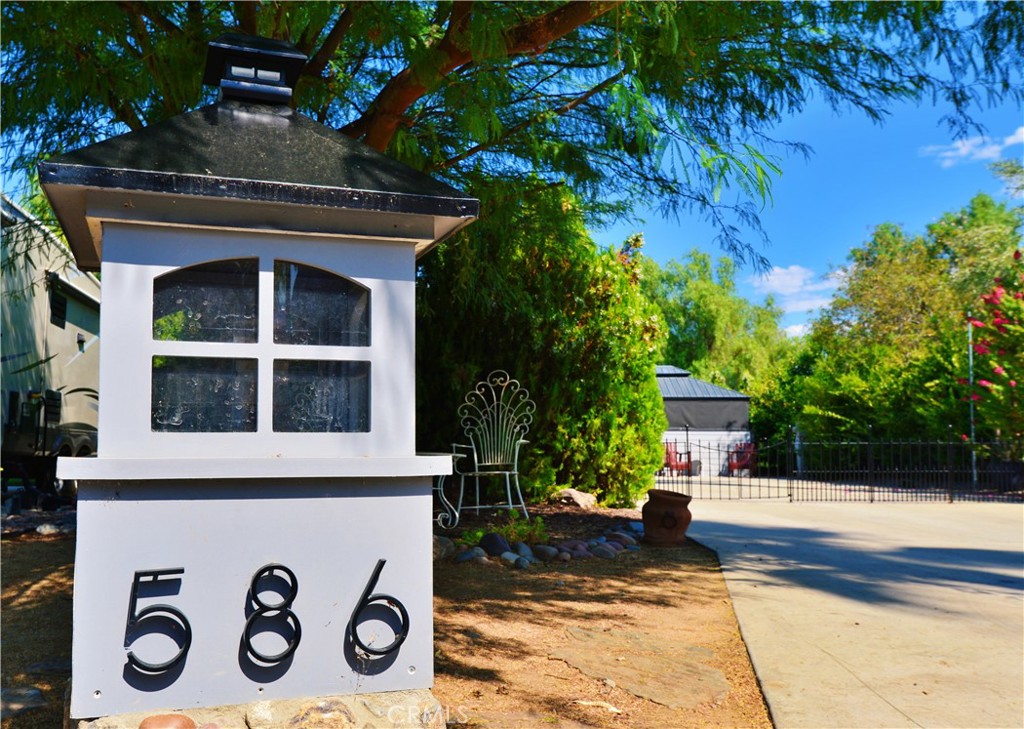 a front view of a house with a tree