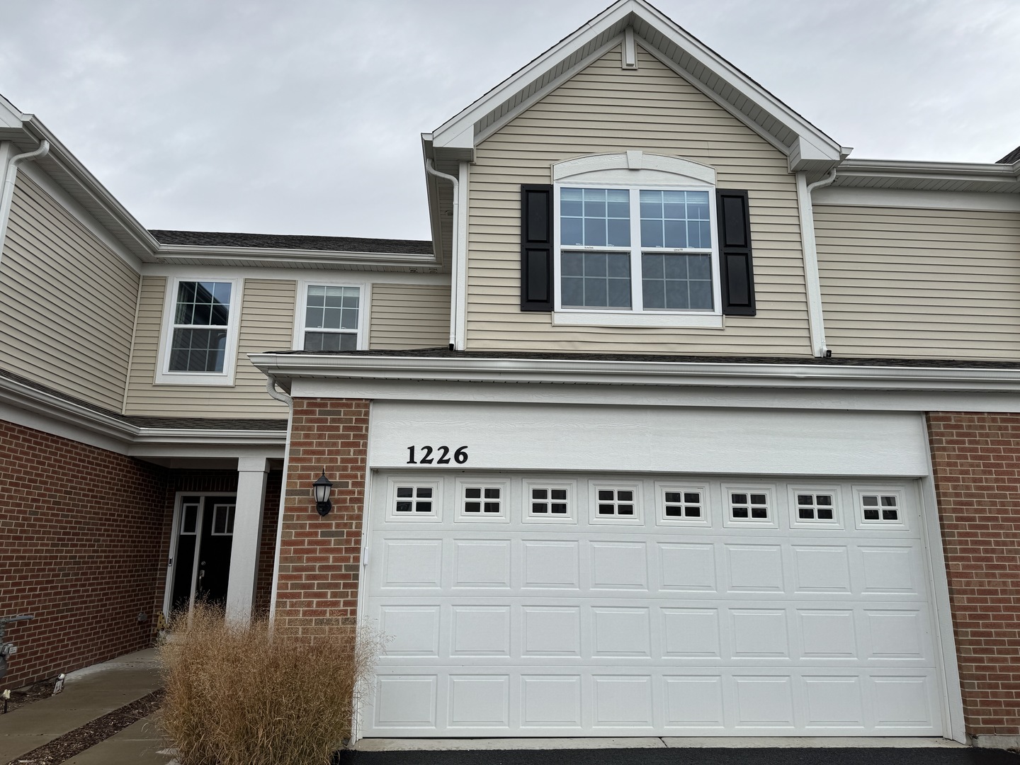 a front view of a house with garage