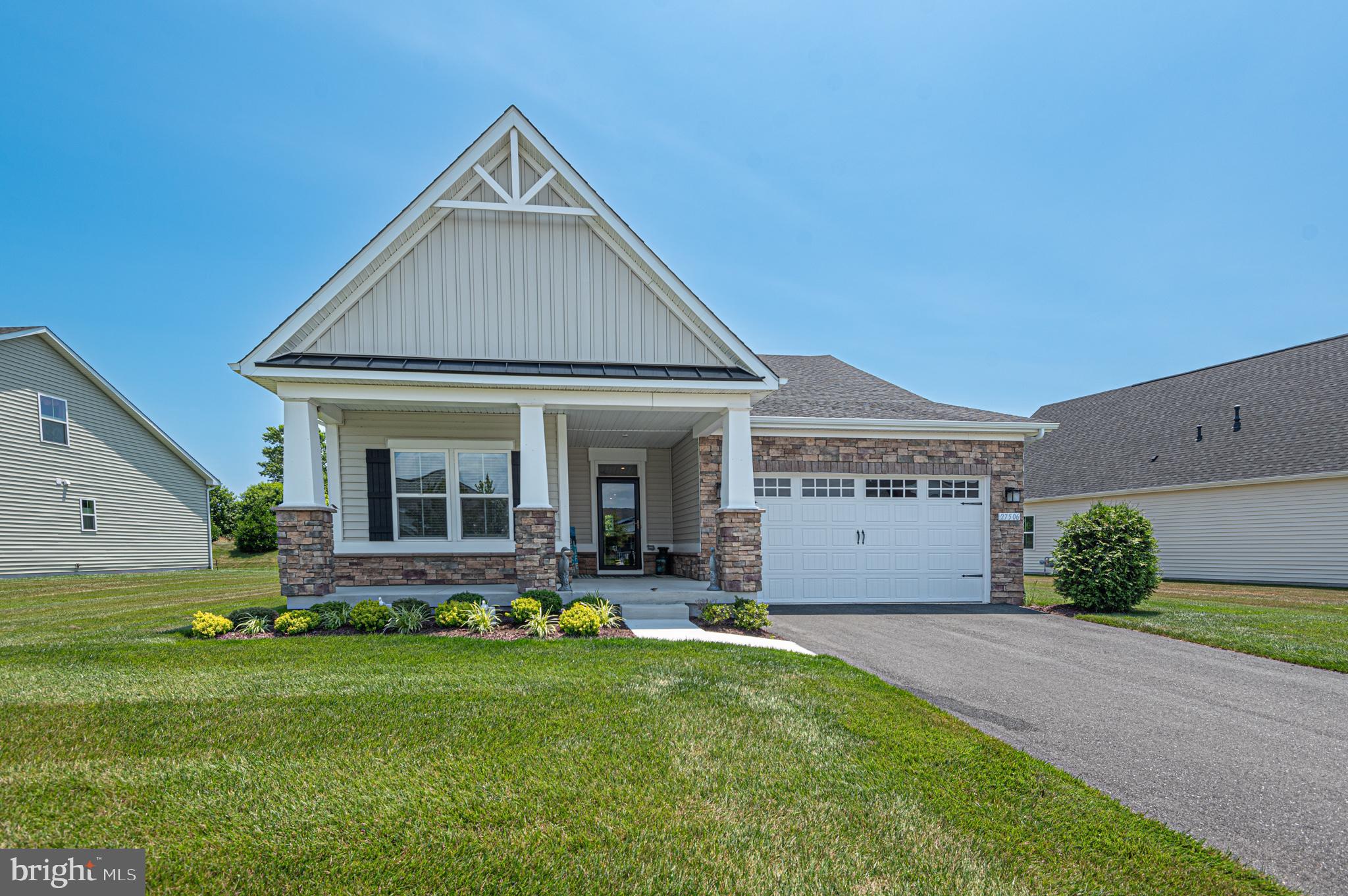 a front view of house with yard and outdoor seating