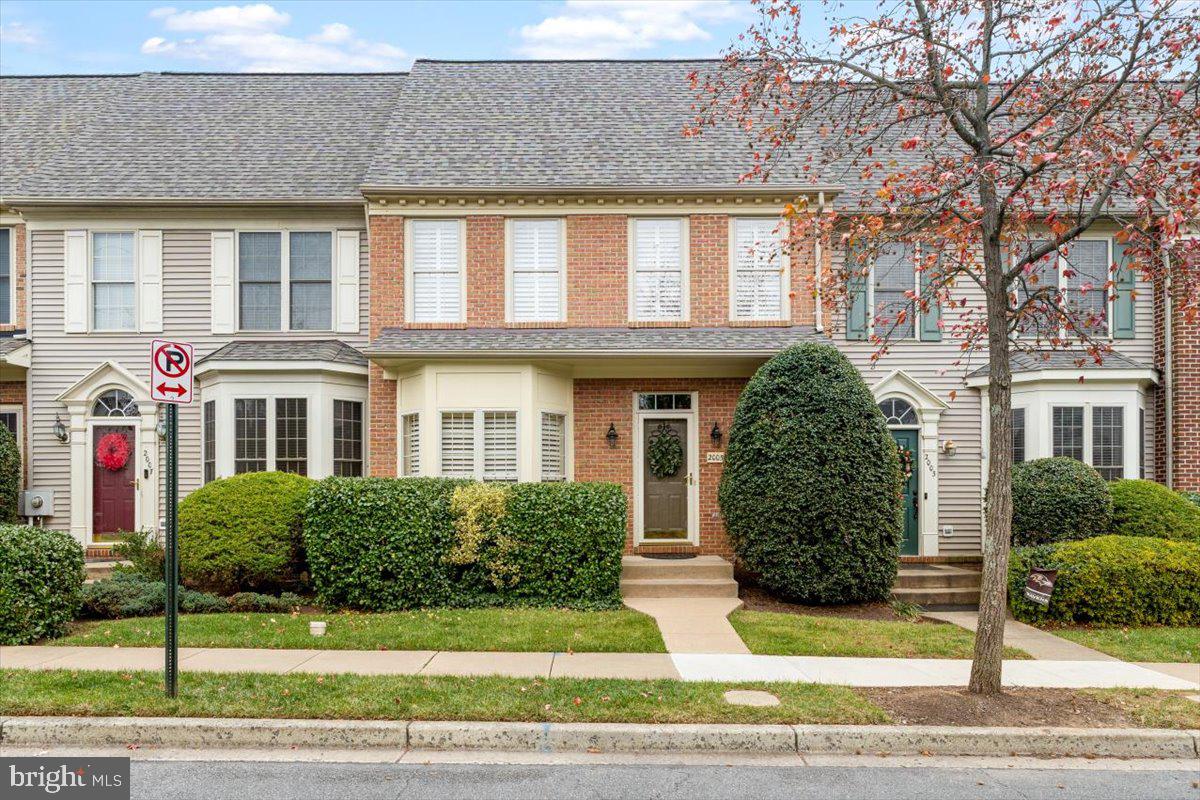 a front view of a house with a yard and plants