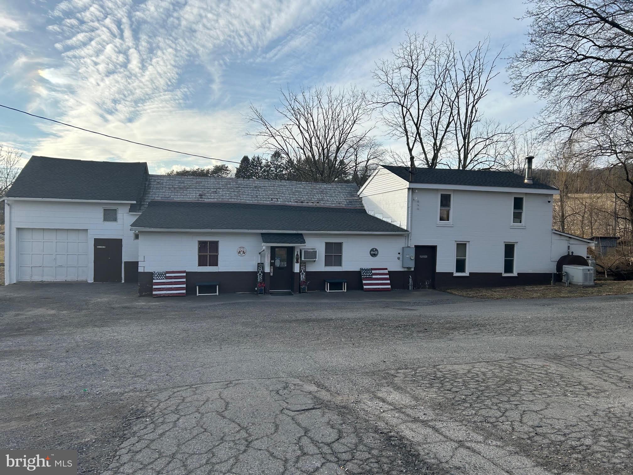 a view of a house with a yard and garage