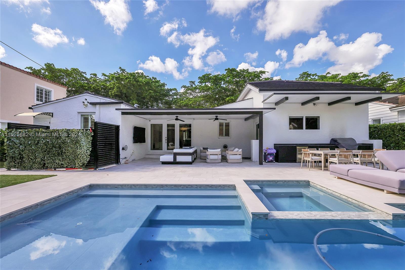 a view of a house with swimming pool and sitting area