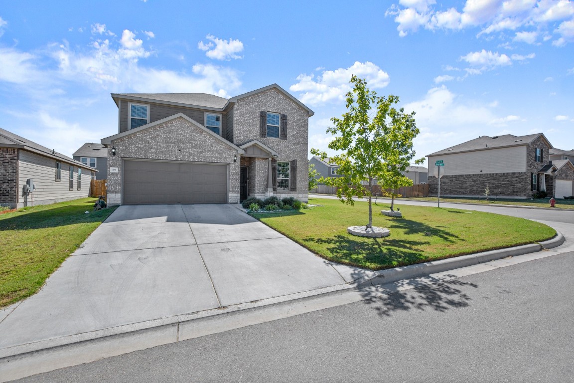 a view of a house with a entertaining space and a small yard