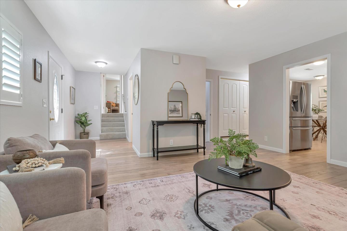 a living room with furniture and a potted plant