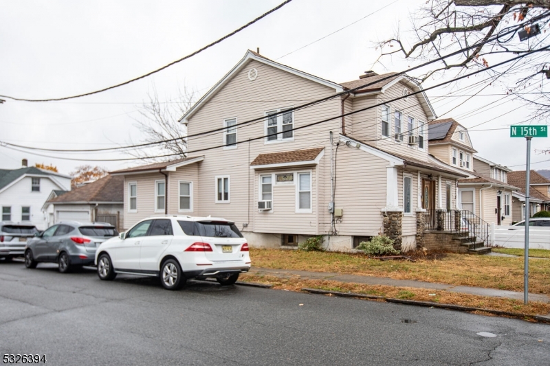 a couple of cars parked in front of a house