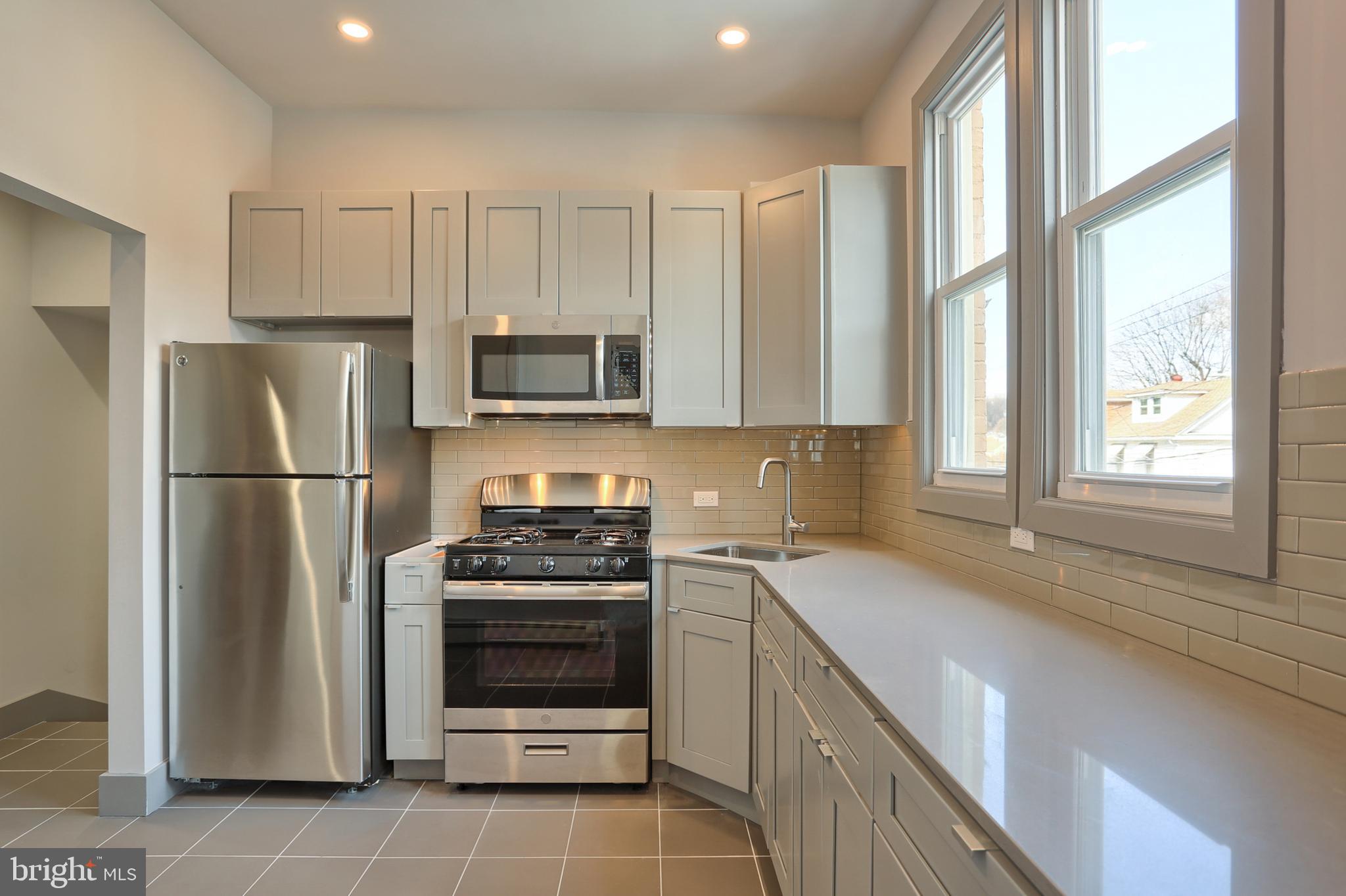 a kitchen with a refrigerator stove and microwave