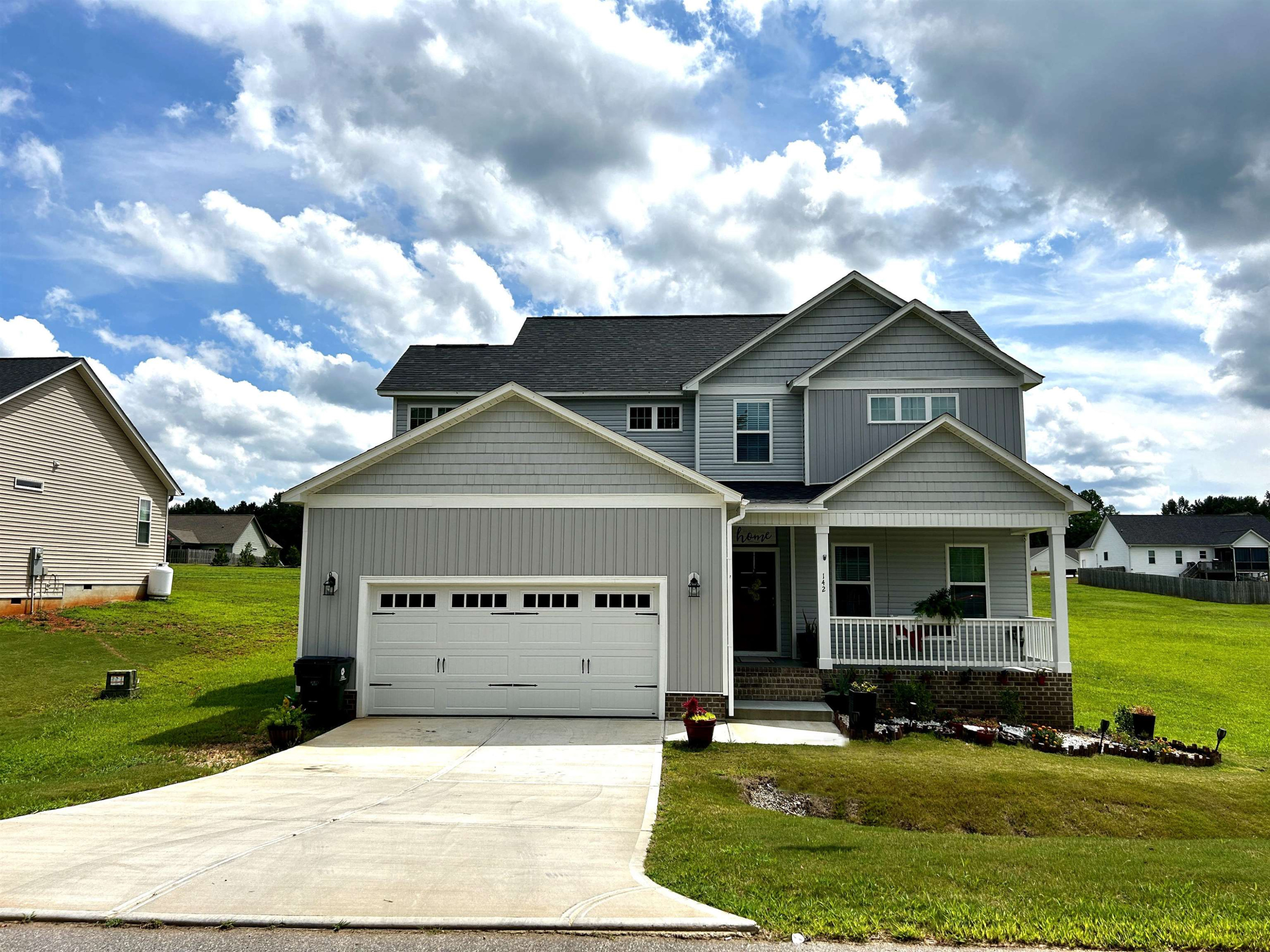 a front view of a house with garden