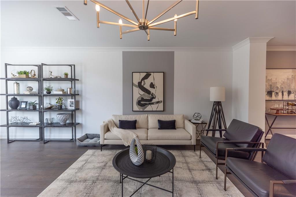 a living room with furniture a rug and a wall painting