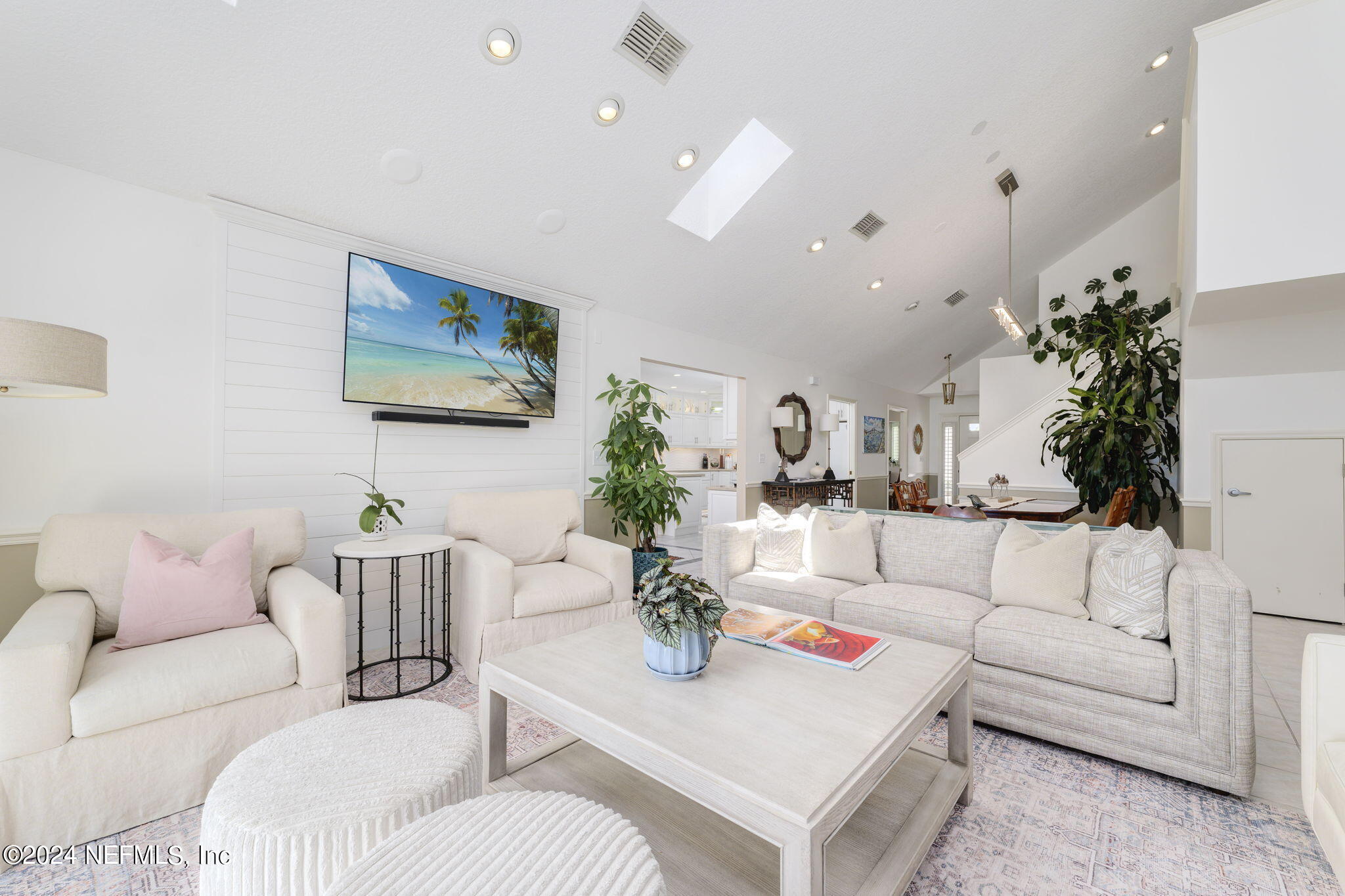 a living room with furniture and a potted plant