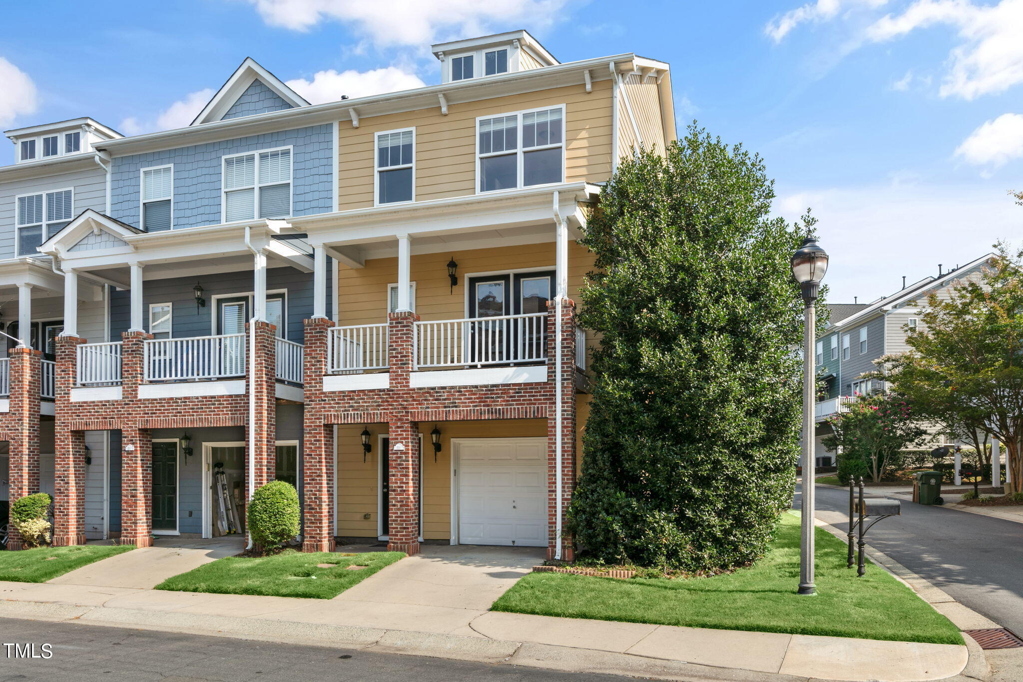 a front view of a residential apartment building with a yard