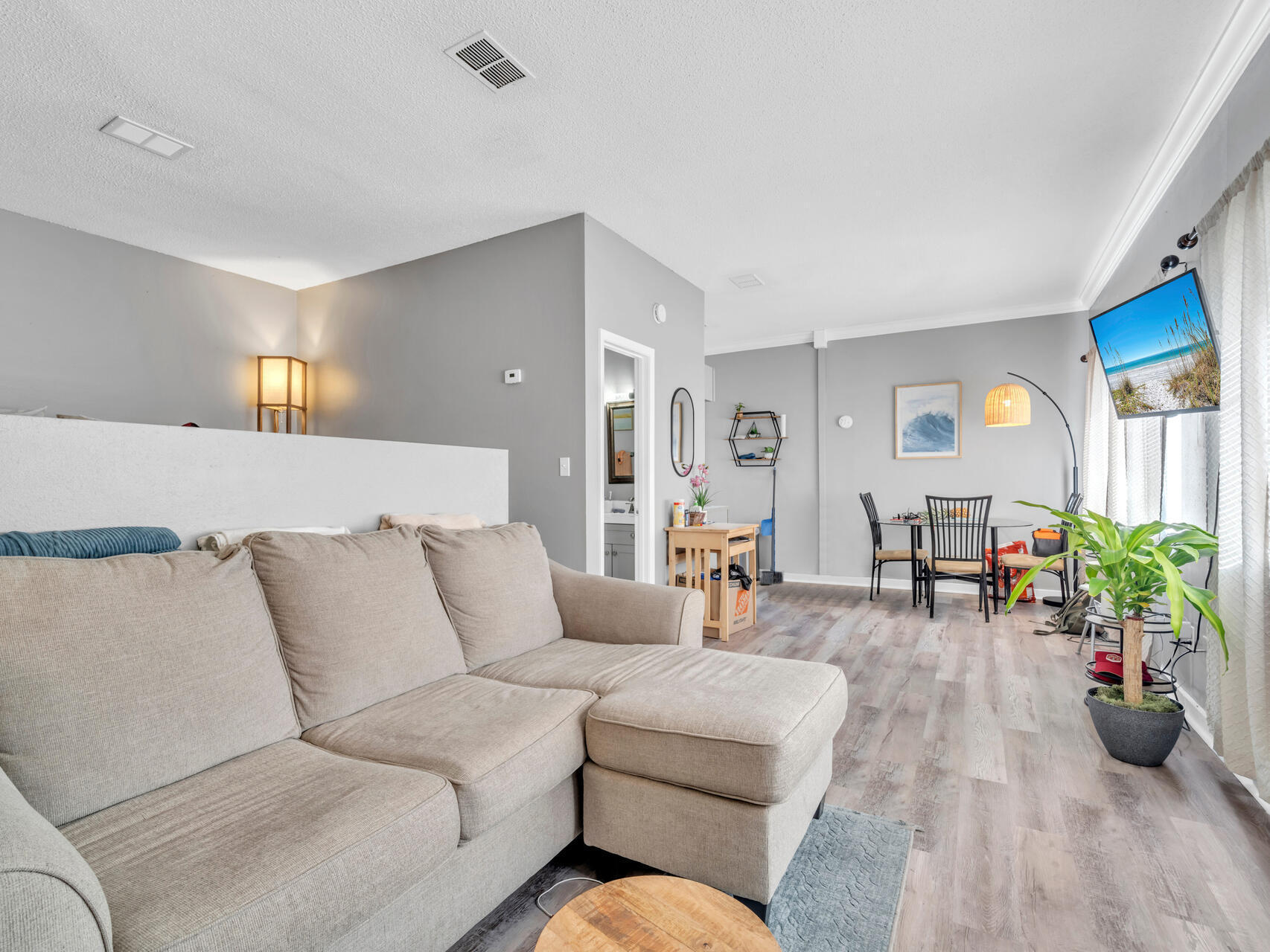 a living room with furniture and wooden floor