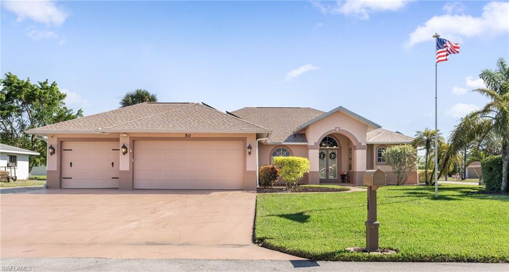 a front view of a house with a garden