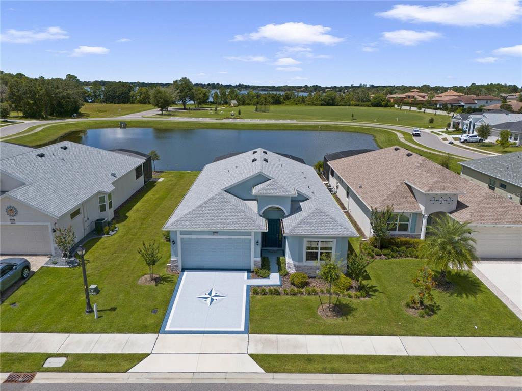 an aerial view of a house with a lake view