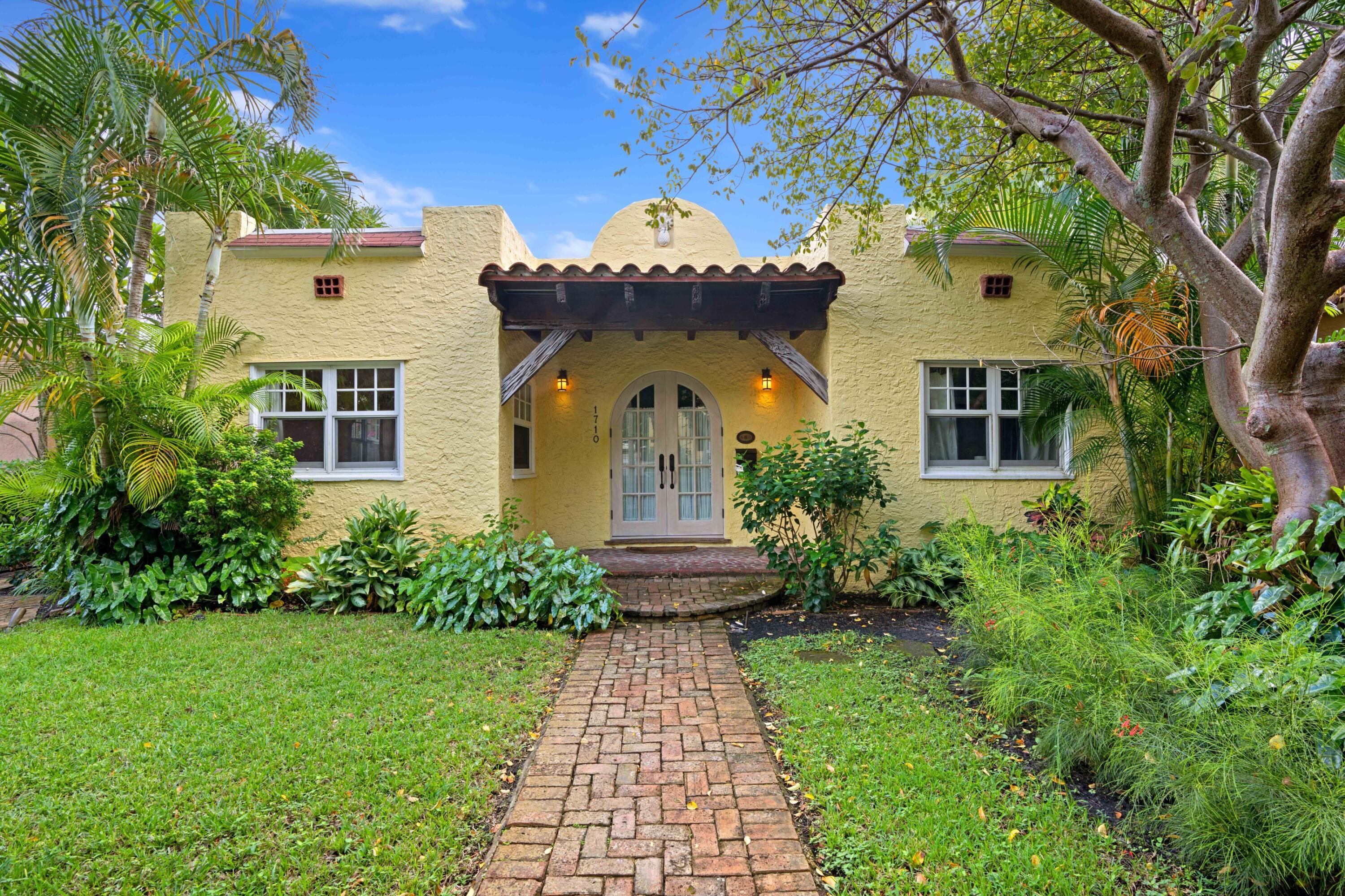 a front view of a house with garden