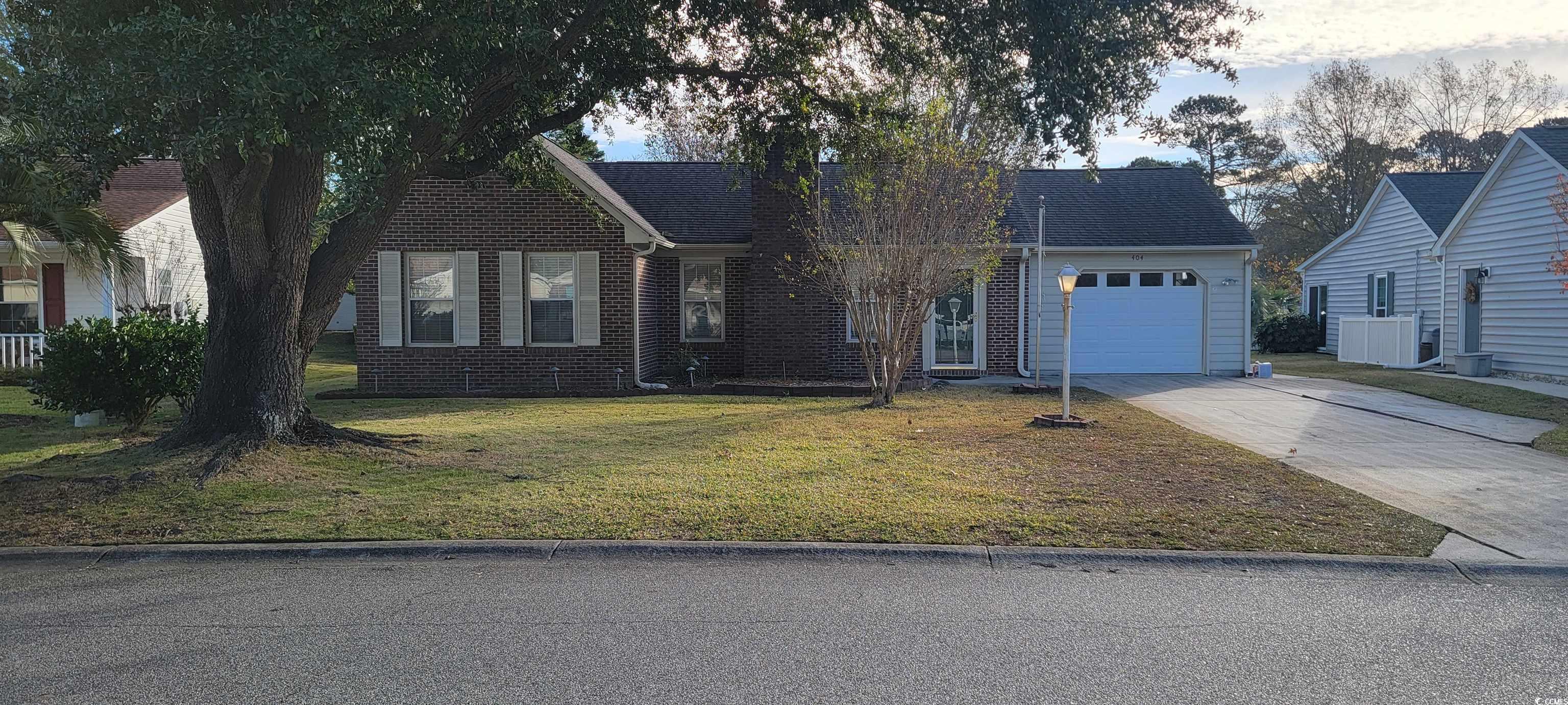 View of front facade with a front yard and a garag