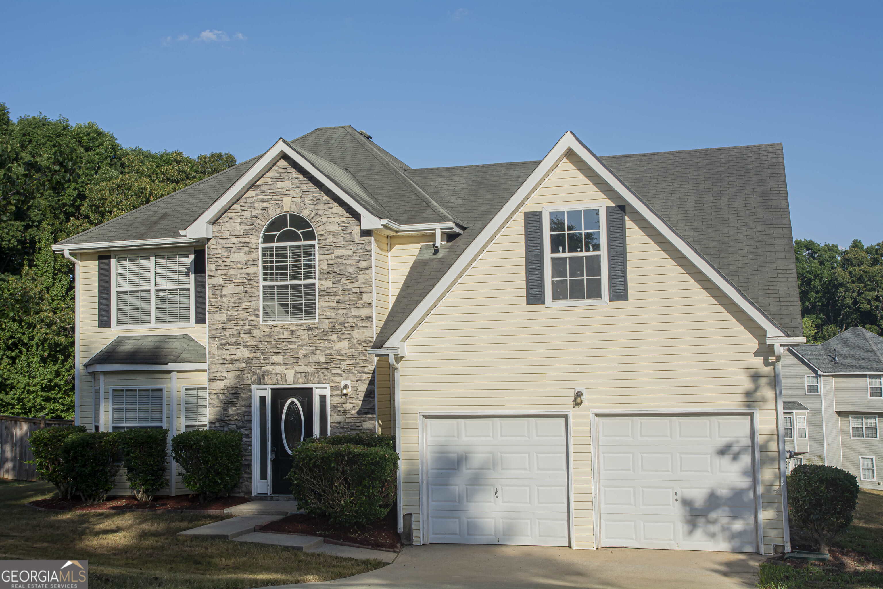 a front view of a house with yard