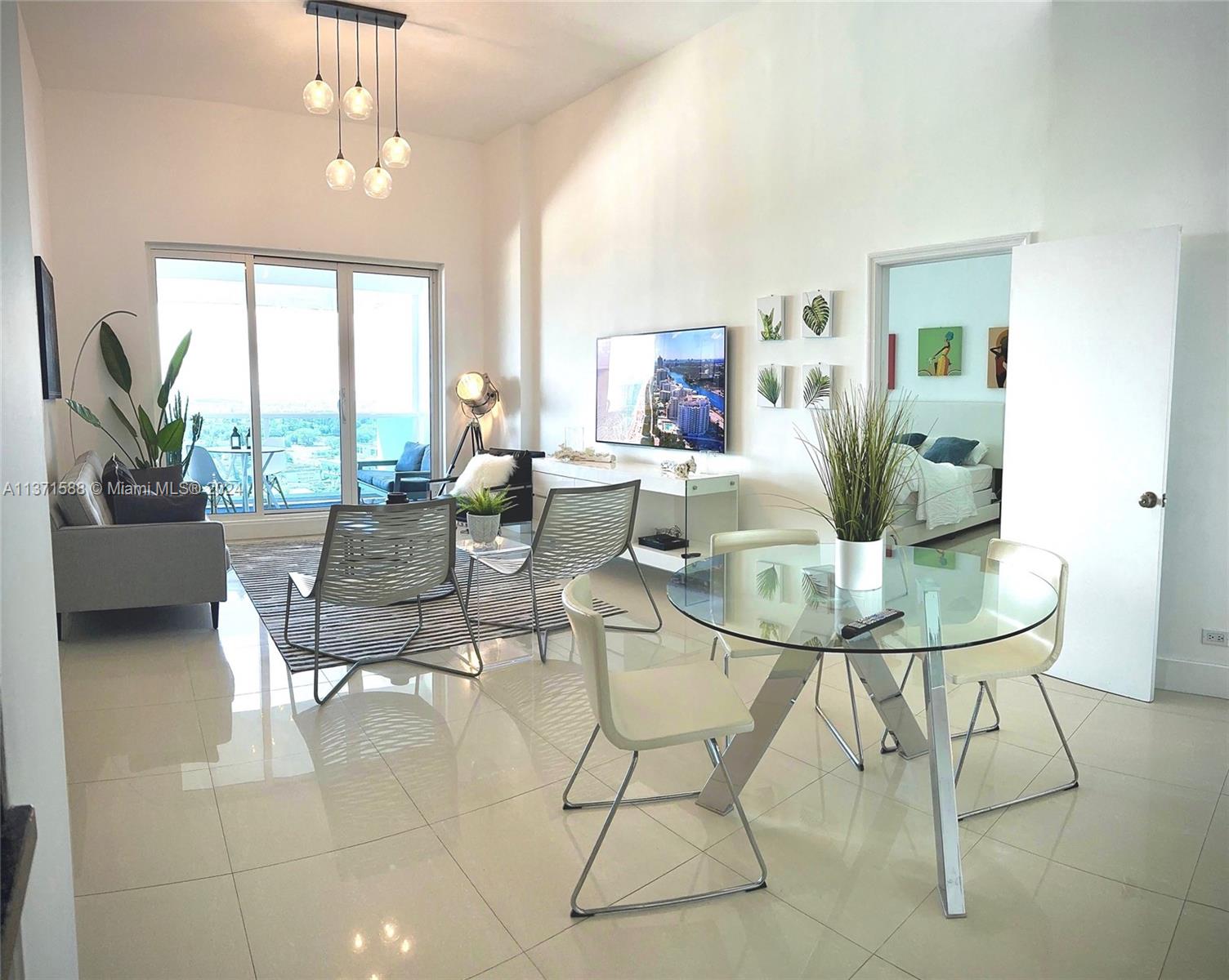 a view of a dining room with furniture and a potted plant