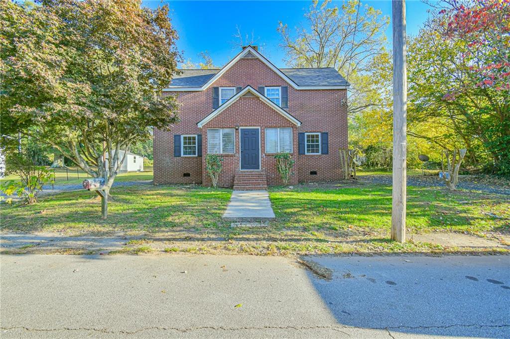 a front view of a house with a yard