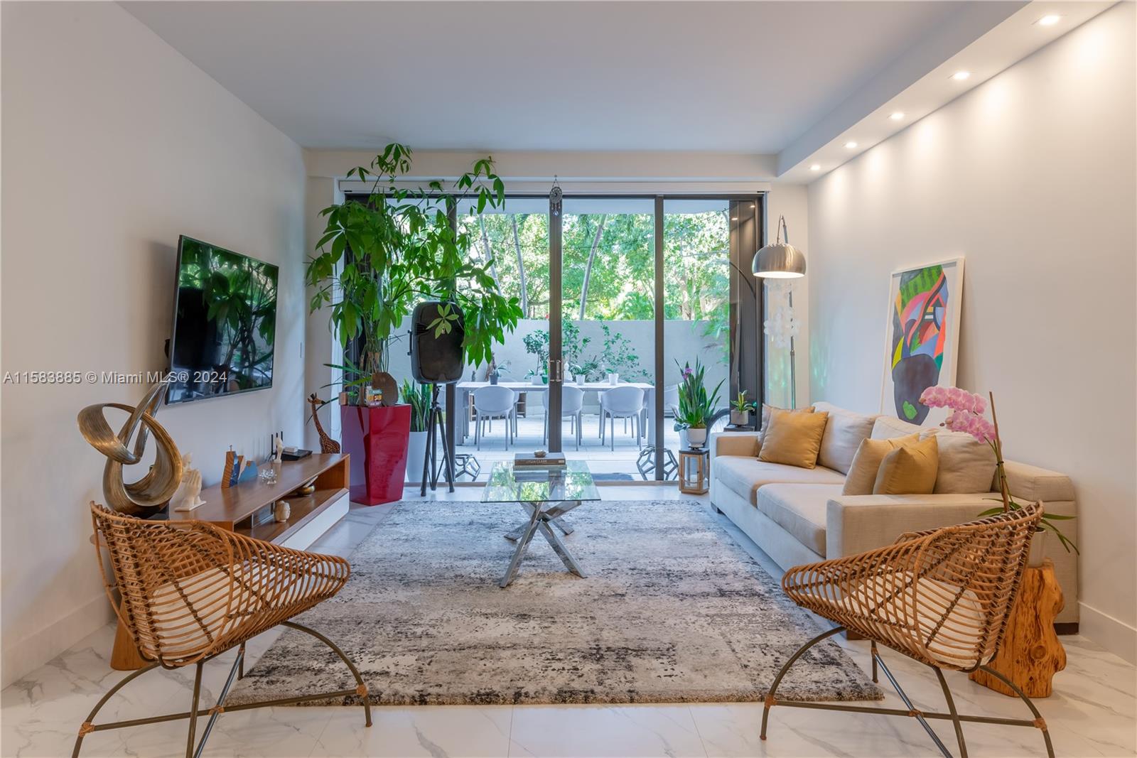 a living room with furniture and a floor to ceiling window