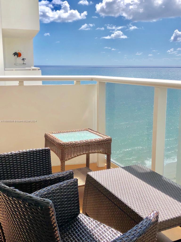 a view of balcony with furniture