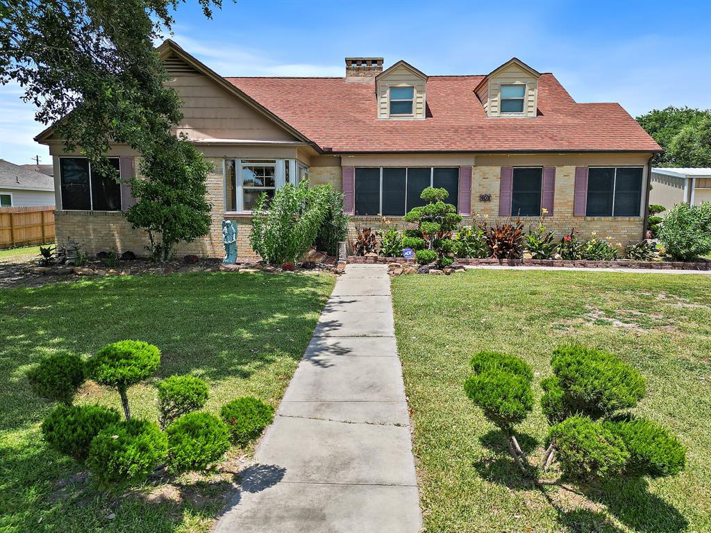 a front view of a house with a garden