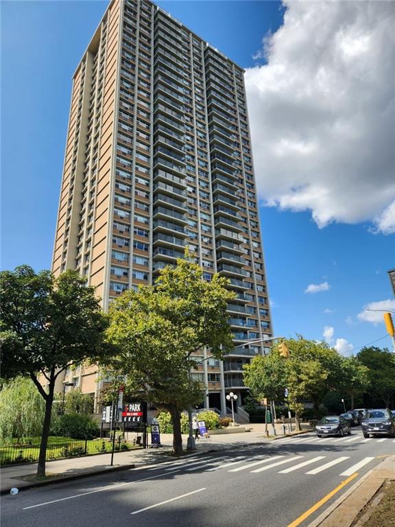 a view of a tall building next to a yard