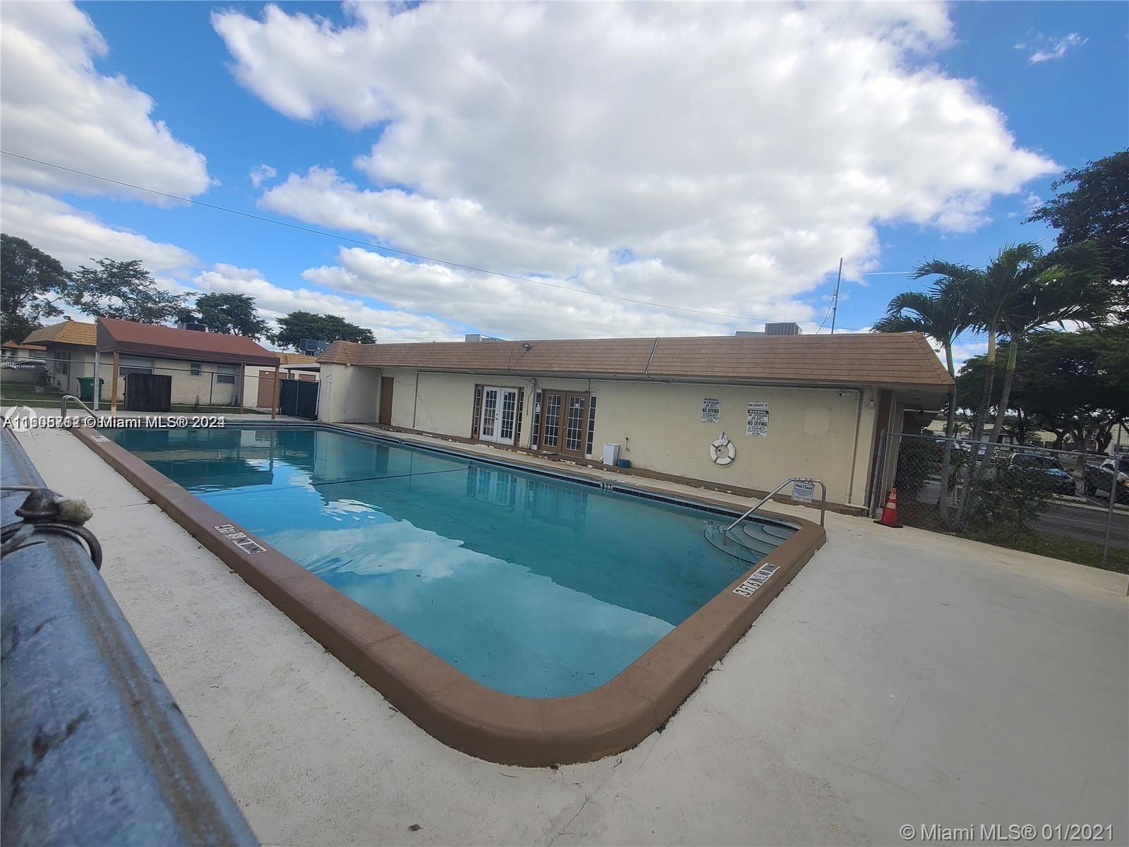 a view of a house with roof deck and sitting area