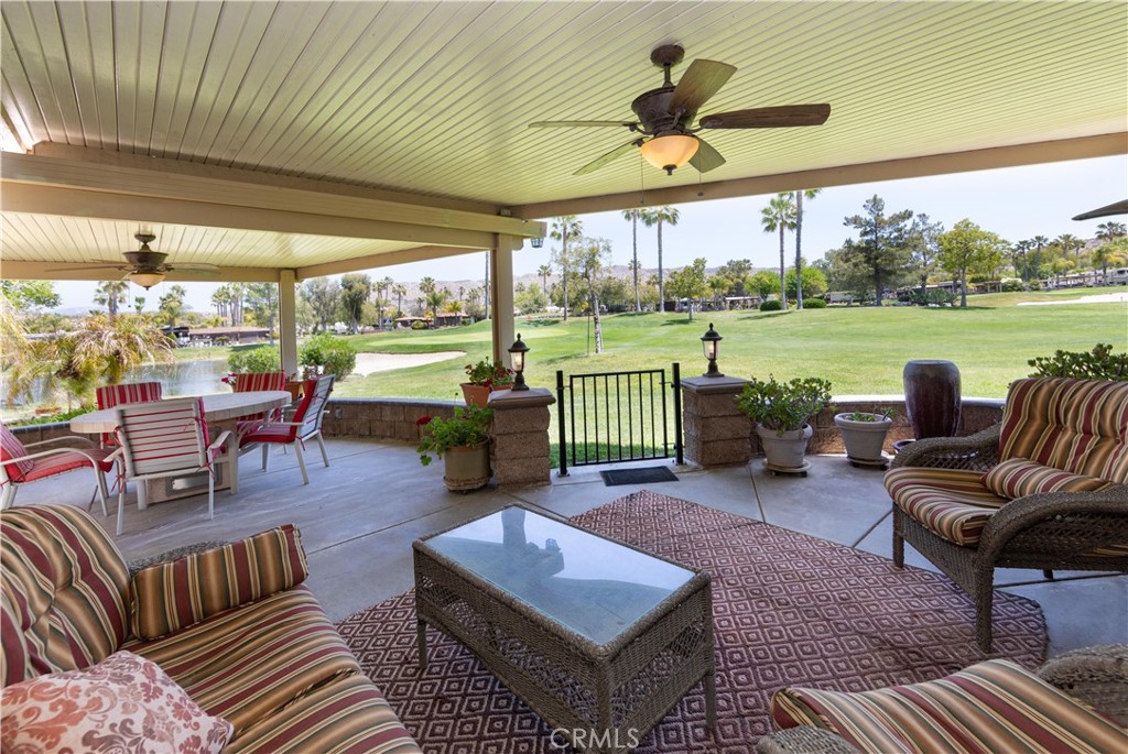 a living room with patio furniture and a floor to ceiling window