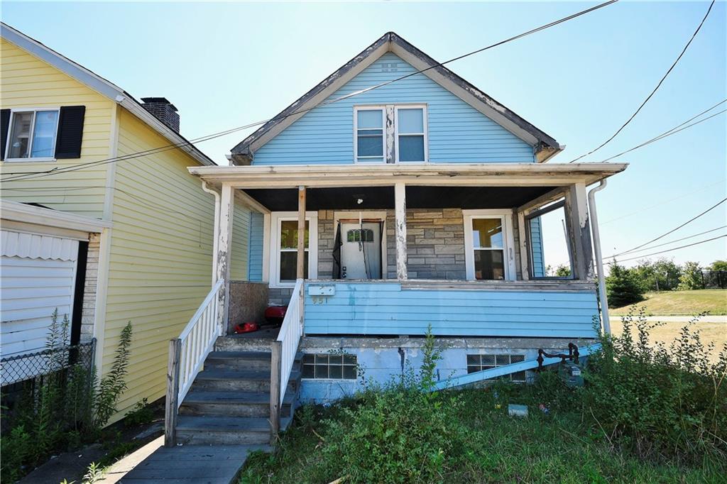 a front view of a house with wooden deck