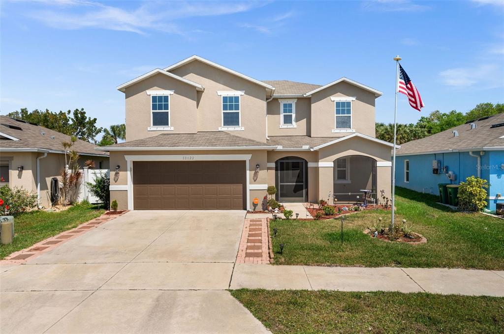 a front view of a house with yard and green space