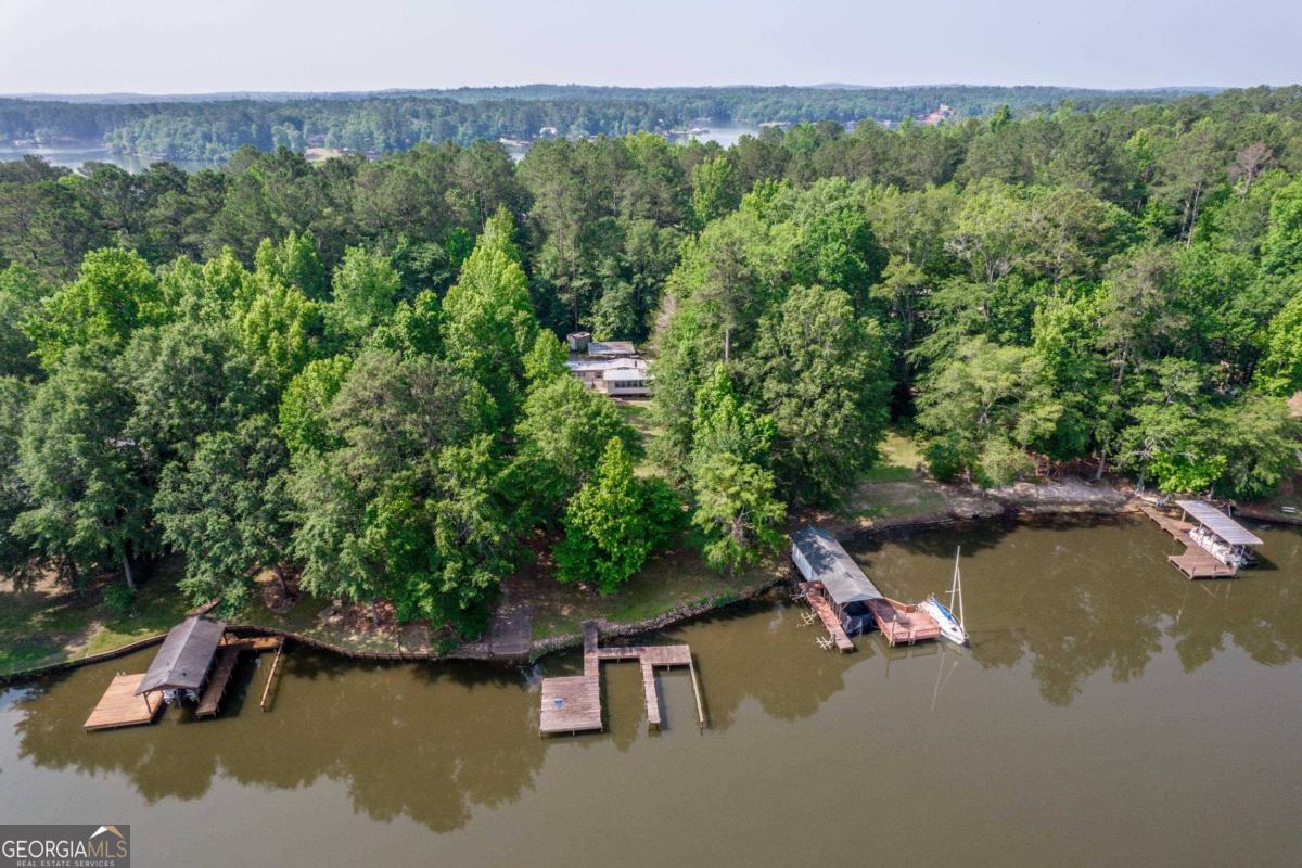 an aerial view of a house with a yard swimming pool and outdoor seating