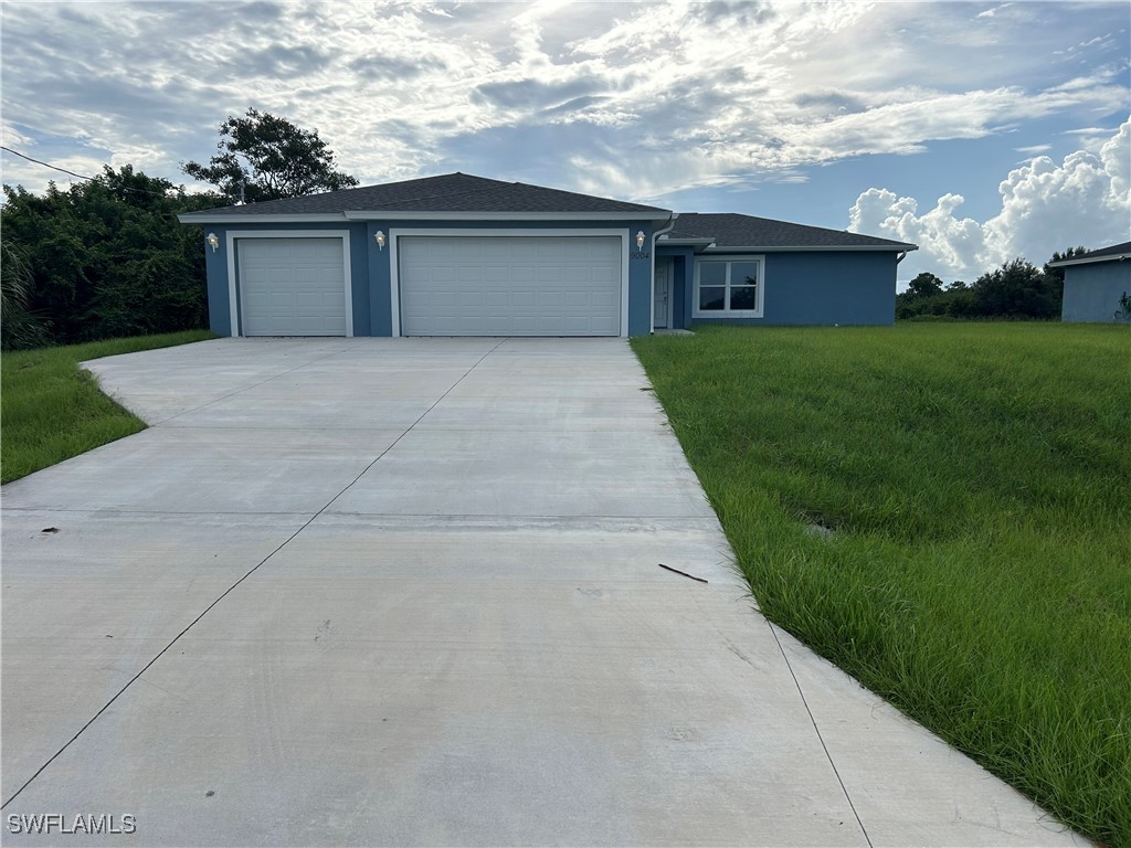 a front view of house with yard and green space