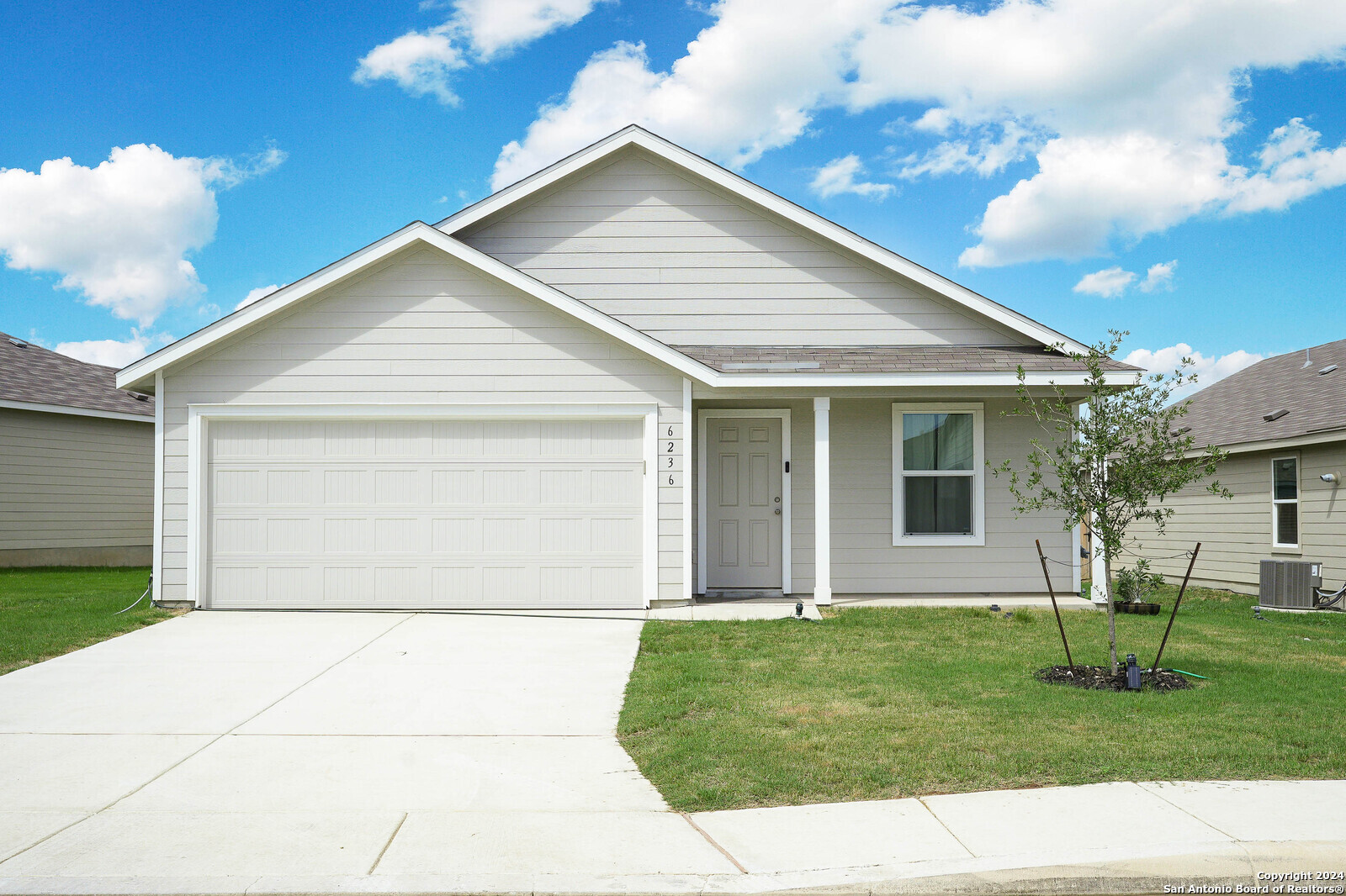 a front view of house with a garden