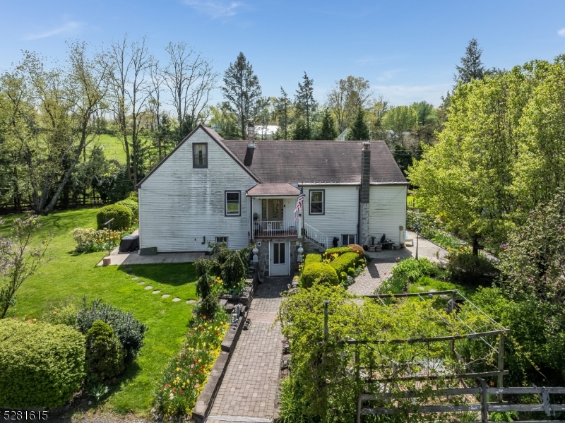 a house with green field in front of it