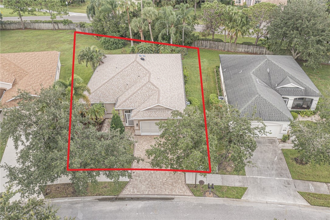 a aerial view of a house with a yard and lake view