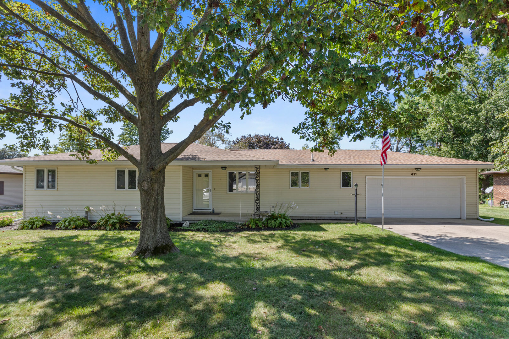 a view of a house with a tree in front of it