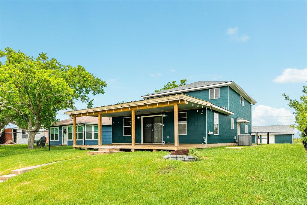 a view of an house with backyard space and balcony