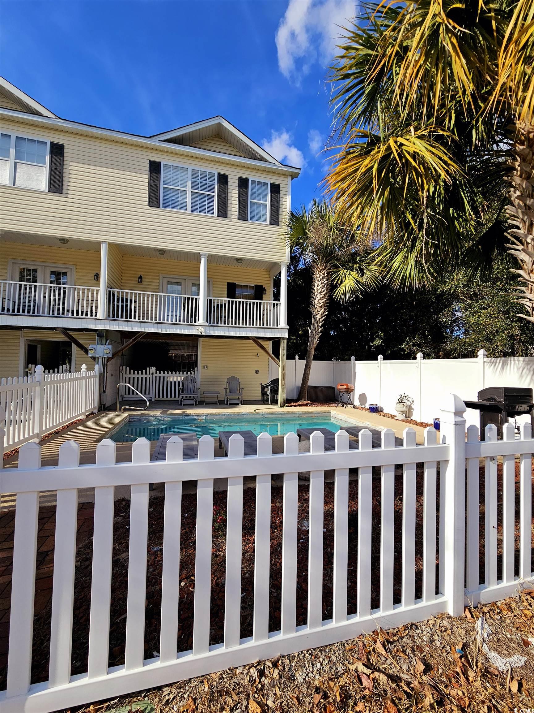 View of front facade featuring a fenced in pool