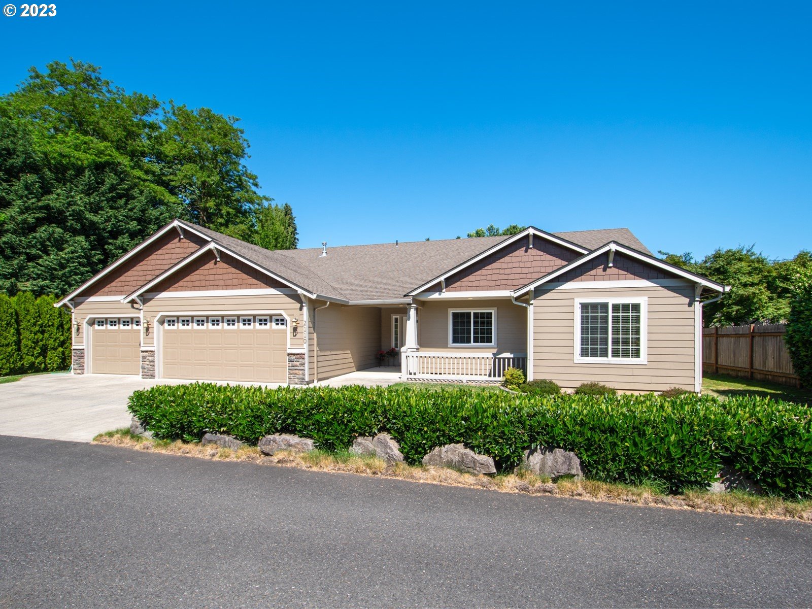 a front view of a house with yard and trees