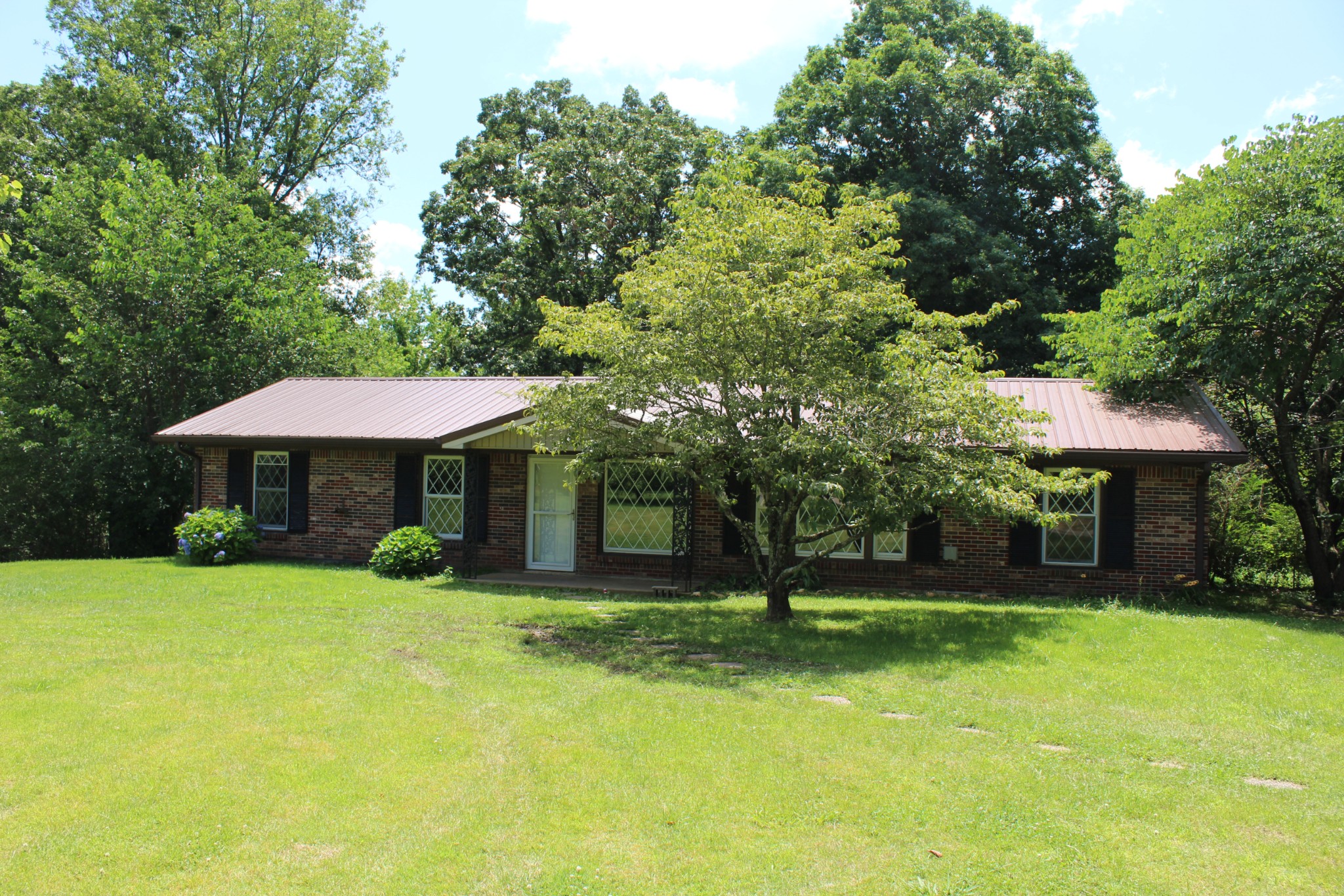 a view of a house with a yard and sitting area