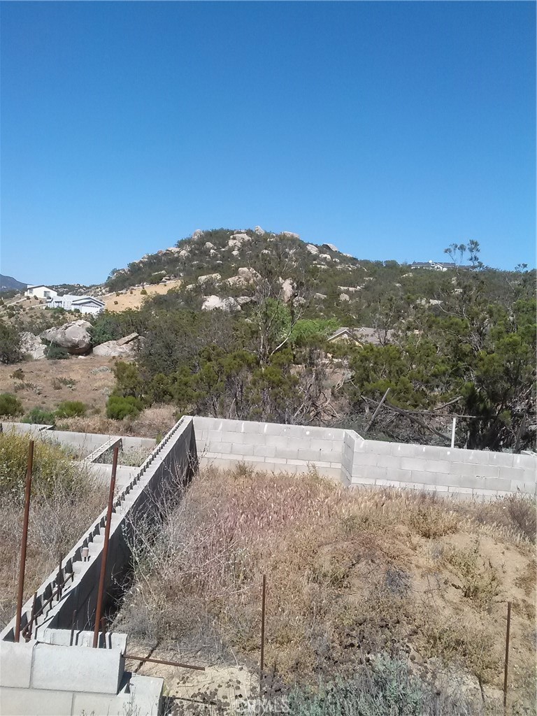 a view of a dry yard with mountains in the background